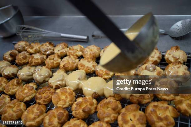 The pastry chef prepares the typical San Isidro doughnuts at Casa Mira, on May 13, 2021 in Madrid, Spain. The different types of donuts such as the...