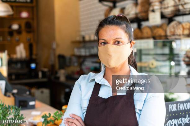 female bakery owner with face mask - reopening ceremony stock pictures, royalty-free photos & images