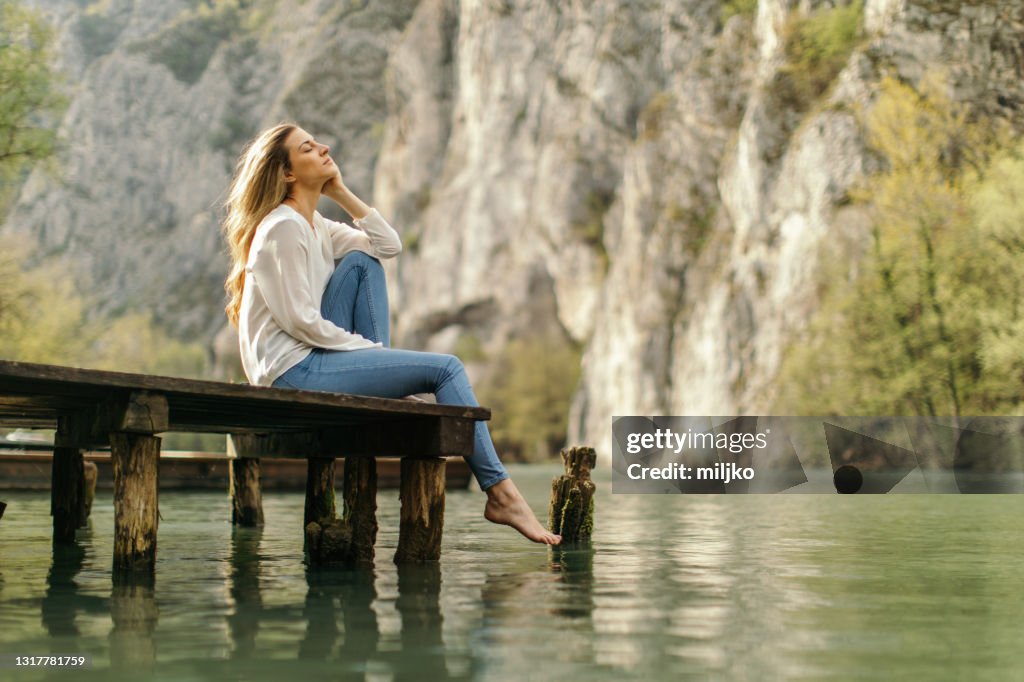 Beautiful woman enjoying next to the river