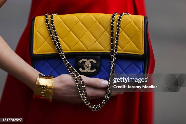 Alexandra Lapp wearing red Valentino jumpsuit, Chanel flap bag in blue, red and yellow and gold Chanel cuff, all via SuperBrands secondhand store on...