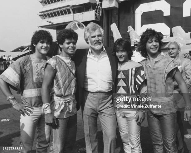 American singer-songwriter and musician Kenny Rogers with four members of Puerto Rican boyband Menudo during the taping of the 'Salute to Lady...