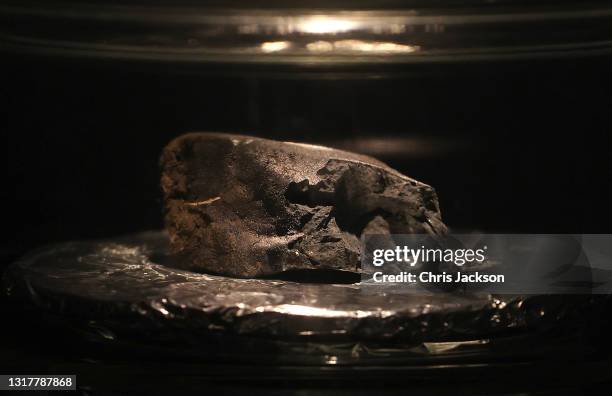 The Winchcombe meteorite sits on display at the Natural History Museum on May 13, 2021 in London, England. The meteorite is a rare type, the first to...