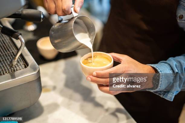 barista pouring milk in a coffee latte cup - buenos aires art stock pictures, royalty-free photos & images