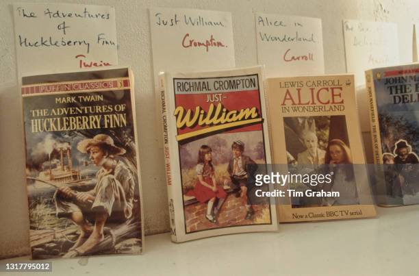 Paperback editions of 'The Adventures of Huckleberry Finn', by Mark Twain, 'Just William', by Richmal Compton, 'Alice in Wonderland', by Lewis...