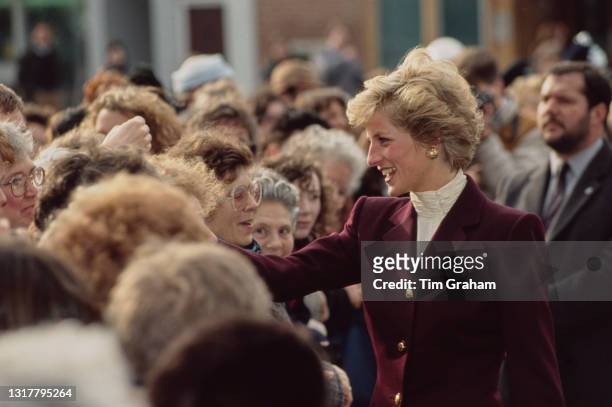 British Royal Diana, Princess of Wales , wearing a burgundy outfit with an ivory polo neck top, greets well-wishers during a visit to Oxford,...