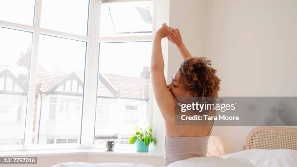 woman stretching in bed - acordando - fotografias e filmes do acervo