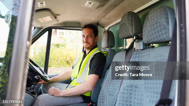 delivery driver in van looking at tablet - 車　作業員 ストックフォトと画像