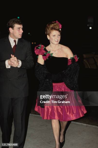British Royals Prince Andrew, Duke of York and Sarah, Duchess of York, wearing a pink-and-black Lindka Cierach dress with floral decoration on the...