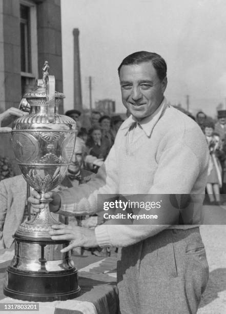 William Turnesa of the United States is presented with the Championship Trophy after winning the Amateur Golf Championship golf tournament on 1st...