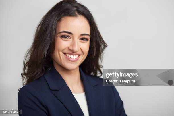 one businesswoman headshot smiling at the camera. - profile portrait stock pictures, royalty-free photos & images