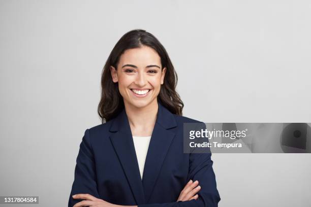 one businesswoman studio portrait looking at the camera. - jacket stock pictures, royalty-free photos & images