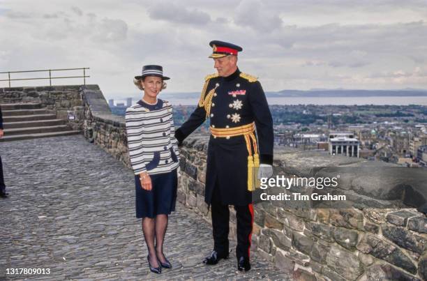 Norwegian Royals Queen Sonja of Norway, wearing a dark blue skirt with a white hooped jacket with dark blue trim and a matching hat, and Harald V of...