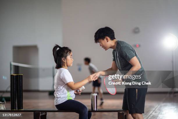 asian chinese female trainer guiding her student practicing posture in badminton court - badminton stock pictures, royalty-free photos & images