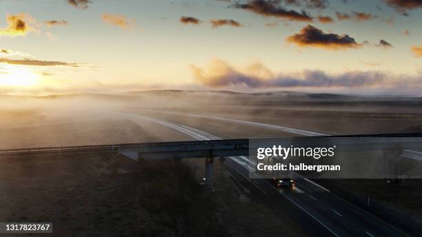 drone shot of truck on freeway on foggy morning - moody sky stock pictures, royalty-free photos & images