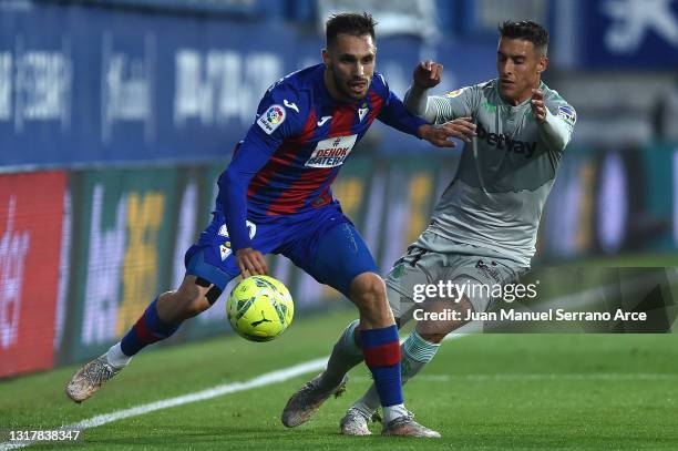 Rober of Eibar tracked by Cristian Tello of Real Betis during the La Liga Santander match between SD Eibar and Real Betis at Estadio Municipal de...