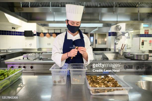 Demi Chef de Partie Megan Coape-Arnold prepares morel mushrooms in the kitchens at The Ritz London on May 13, 2021 in London, England. After closing...