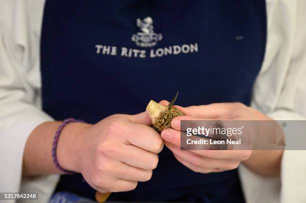 Demi Chef de Partie Megan Coape-Arnold prepares morel mushrooms in the kitchens at The Ritz London on May 13, 2021 in London, England. After closing...