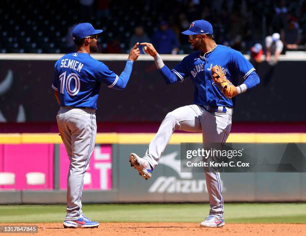 Marcus Semien and Lourdes Gurriel Jr. #13 of the Toronto Blue Jays celebrate their 8-4 win over the Atlanta Braves at Truist Park on May 13, 2021 in...