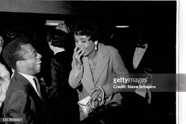 American Civil Rights activists author James Baldwin and actress & singer Lena Horne share a laugh at an unspecified event, New York, 1965.