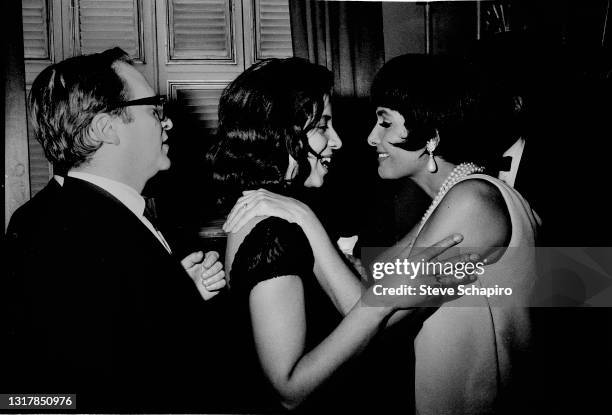 View of, from left, married American couple, film director Sidney Lumet and author Gail Jones Lumet , the latter of whom shares a smile with and...