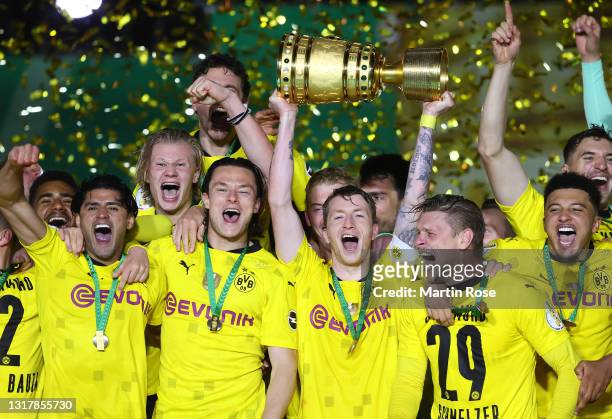 Team captain Marco Reus of Dortmund lifts the trophy as his team mates celebrate after winning the DFB Cup final match between RB Leipzig and...