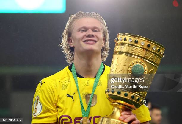 Erling Haaland of Borussia Dortmund celebrates with the trophy after winning the DFB Cup final match between RB Leipzig and Borussia Dortmund at...
