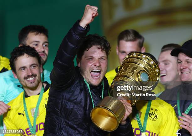 Head coach Edin Terzic of Borussia Dortmund celebrates with the trophy after winning the DFB Cup final match between RB Leipzig and Borussia Dortmund...