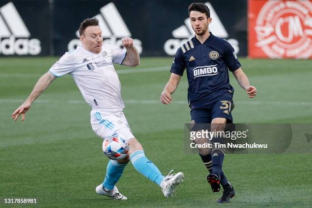 Leon Flach of the Philadelphia Union passes over Thomas McNamara of the New England Revolution during the first half at Subaru Park on May 12, 2021...