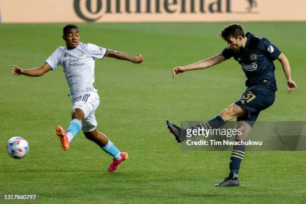 Leon Flach of the Philadelphia Union shoots past Maciel of the New England Revolution during the first half at Subaru Park on May 12, 2021 in...