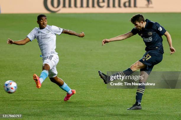 Leon Flach of the Philadelphia Union shoots past Maciel of the New England Revolution during the first half at Subaru Park on May 12, 2021 in...