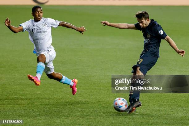 Leon Flach of the Philadelphia Union shoots past Maciel of the New England Revolution during the first half at Subaru Park on May 12, 2021 in...