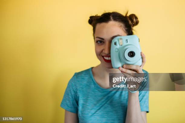 young woman takes photo with a polaroid. - bildnis bildbanksfoton och bilder