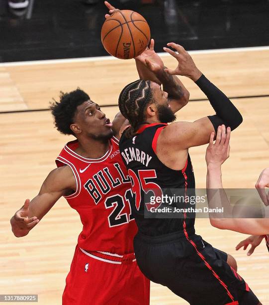 Thaddeus Young of the Chicago Bulls blocks a shot by DeAndre' Bembry of the Toronto Raptors at the United Center on May 13, 2021 in Chicago,...