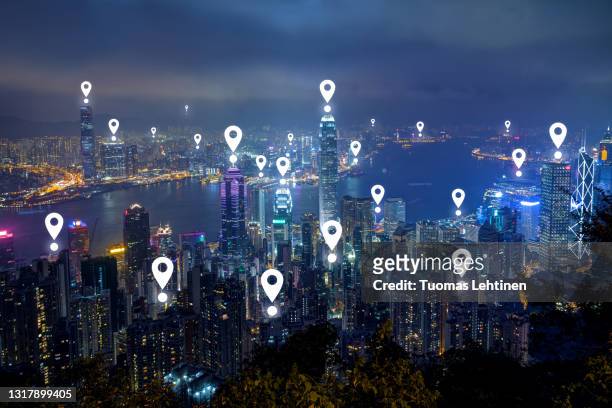 map pin icons on hong kong's skyline at dusk. - hong kong map stock pictures, royalty-free photos & images