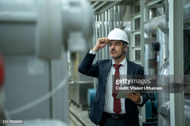 factory engineer checking high pressure water pipe in boiler room. - väg och vattenbyggnadsingenjör bildbanksfoton och bilder