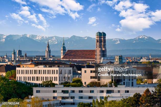 old town with cathedral against mountain range, munich, bavaria, germany - munich stock pictures, royalty-free photos & images
