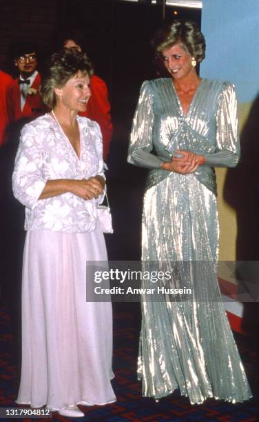 Diana, Princess of Wales, wearing a silver lame dress with an open back designed by Bruce Oldfield, attends the Film Premiere of 'Burke & Wills' on...