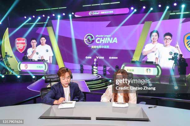 Commentators Xu Ye and Liu Yuyang react during the semi-finals of the ePremier League China Tournament 2021 at Wisdom Bay Studio on May 14, 2021 in...