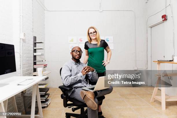 portrait of young business partners in design office - studio office stock-fotos und bilder