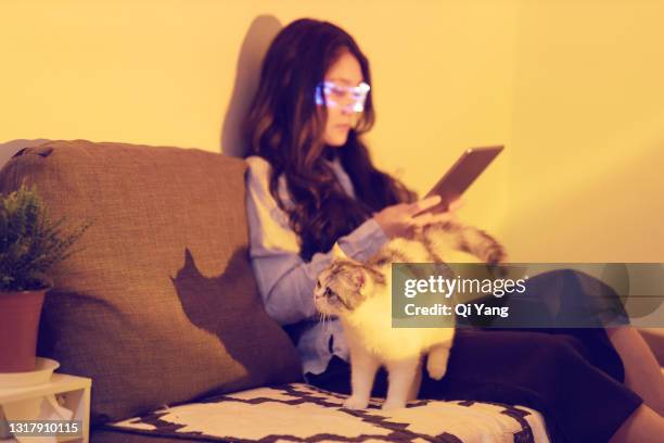 woman wearing augmented reality glasses using a digital tablet - augmented reality animal stock-fotos und bilder