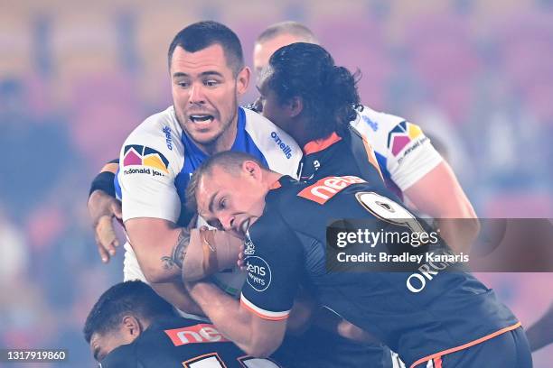 David Klemmer of the Knights is tackled during the round 10 NRL match between the Wests Tigers and the Newcastle Knights at Suncorp Stadium, on May...