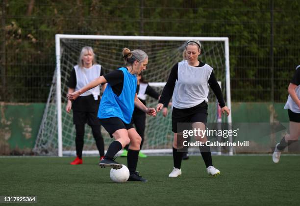 women compete in a football match - menopossibilities stock-fotos und bilder