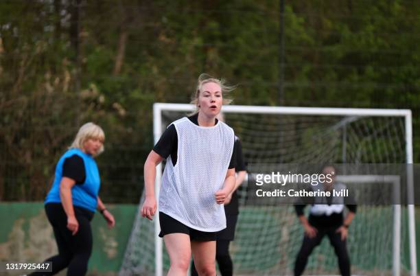 women compete in a football match - menopossibilities stock-fotos und bilder