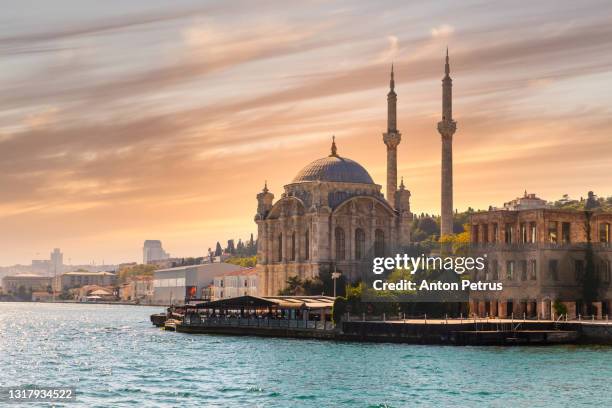 ortakoy mosque at sunset, istanbul, turkey - galata tower stock-fotos und bilder