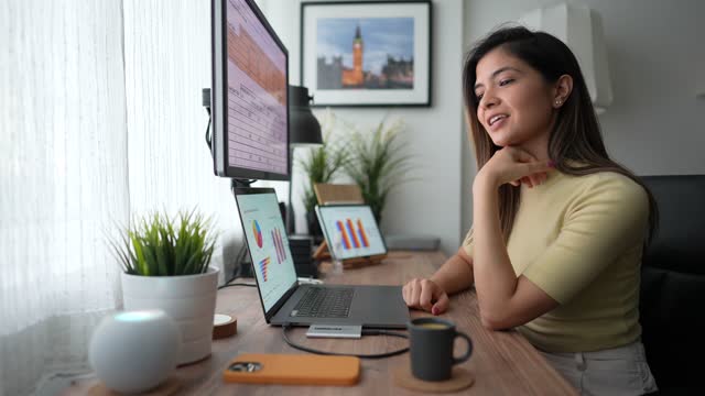 Woman working at home talks to virtual assistant