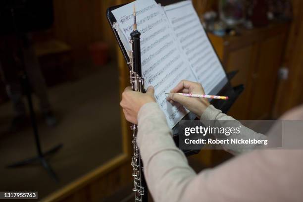 British oboe instructor marks a score sheet for an Afghan student during class at the Afghan National Institute of Music September 6, 2016 in Kabul,...