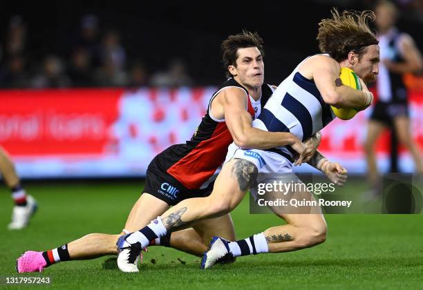 Zach Tuohy of the Cats is tackled by Jack Steele of the Saints during the round 9 AFL match between the St Kilda Saints and the Geelong Cats at...