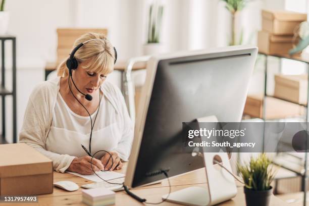 woman receiving orders for shipping - elderly receiving paperwork stock pictures, royalty-free photos & images