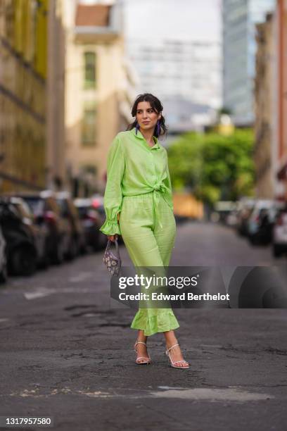 Ketevan Giorgadze @katie.one wears long metal H&M earrings decorated with faceted plastic beads, a linen green oversized lounge The Sleeper shirt...