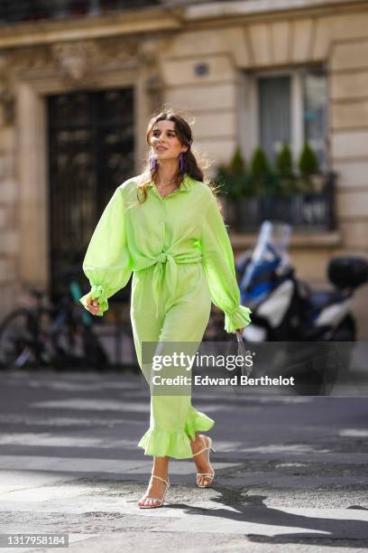 Ketevan Giorgadze @katie.one wears long metal H&M earrings decorated with faceted plastic beads, a linen green oversized lounge The Sleeper shirt...